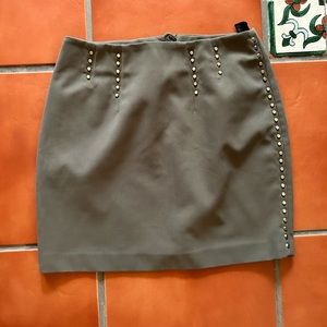 Army green skirt with gold studs.